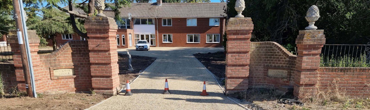 This is a photo of a newly installed chip and tar driveway, installed by Finedon Driveways